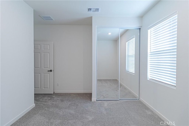 41207 Alegria Ln, Lake Elsinore, CA 92532 - unfurnished bedroom featuring carpet, multiple windows, a closet, and baseboards