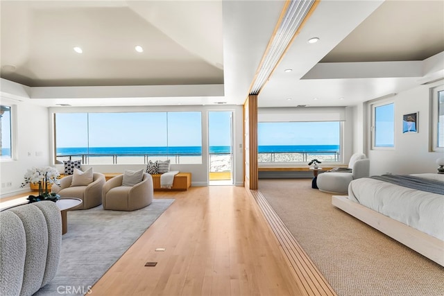 1554 E Oceanfront, Newport Beach, CA 92661 - bedroom with wood finished floors, recessed lighting, access to exterior, a water view, and baseboards