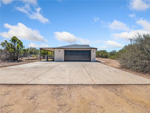 10683 El Centro Rd, Oak Hills, CA 92344 - garage featuring driveway and fence