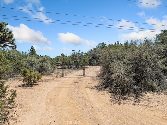 10683 El Centro Rd, Oak Hills, CA 92344 - view of road with a gate and a rural view