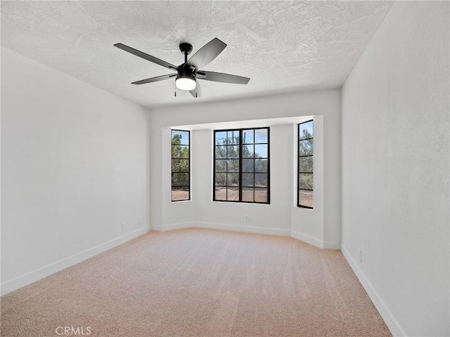 10683 El Centro Rd, Oak Hills, CA 92344 - unfurnished room featuring light colored carpet, a textured ceiling, ceiling fan, and baseboards