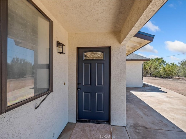 10683 El Centro Rd, Oak Hills, CA 92344 - entrance to property with stucco siding
