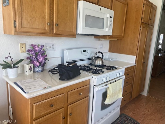10815 Cherry Hls, Cherry Valley, CA 92223 - kitchen featuring white appliances, wood finished floors, light countertops, and brown cabinetry