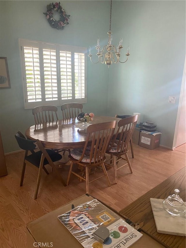 10815 Cherry Hls, Cherry Valley, CA 92223 - dining space featuring a chandelier, light wood-style floors, and baseboards