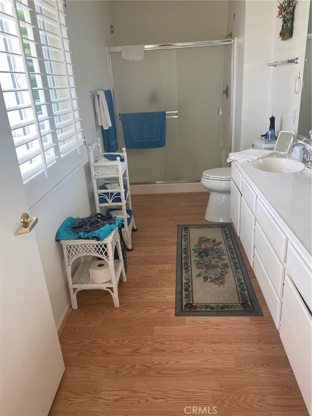 10815 Cherry Hls, Cherry Valley, CA 92223 - bathroom featuring wood finished floors, a shower stall, toilet, and vanity