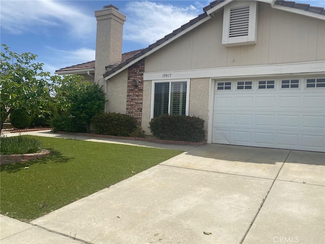 10815 Cherry Hls, Cherry Valley, CA 92223 - view of side of property featuring driveway, a chimney, a lawn, and a tile roof