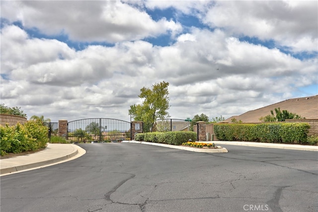 1931 James Gaynor St, Fallbrook, CA 92028 - view of asphalt road featuring a gate, curbs, a gated entry, and sidewalks