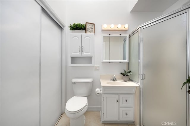 full bathroom featuring a stall shower, tile patterned floors, toilet, and vanity