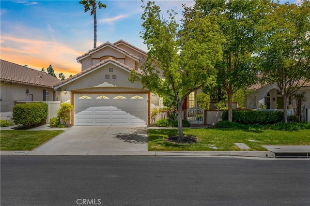 40686 Via Jalapa, Murrieta, CA 92562 - view of front of home featuring driveway, an attached garage, stucco siding, and a tile roof