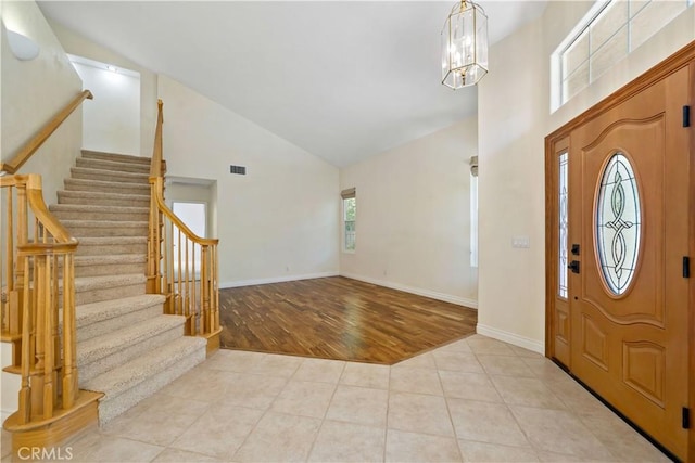 40686 Via Jalapa, Murrieta, CA 92562 - entryway with high vaulted ceiling, stairway, tile patterned flooring, a chandelier, and baseboards