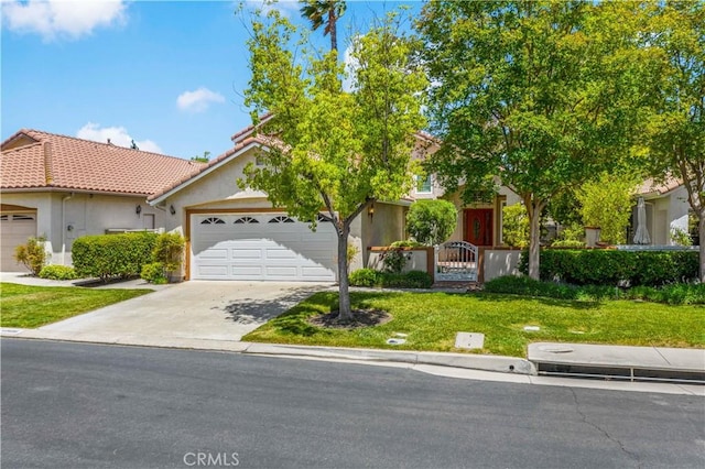 40686 Via Jalapa, Murrieta, CA 92562 - obstructed view of property with concrete driveway, a tiled roof, stucco siding, and a garage