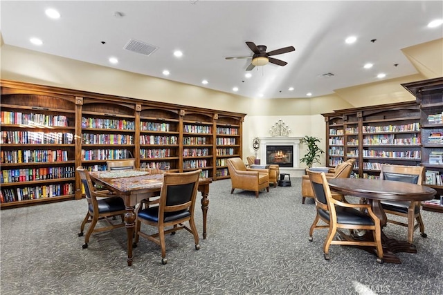 40686 Via Jalapa, Murrieta, CA 92562 - carpeted dining area with a ceiling fan, recessed lighting, and a glass covered fireplace