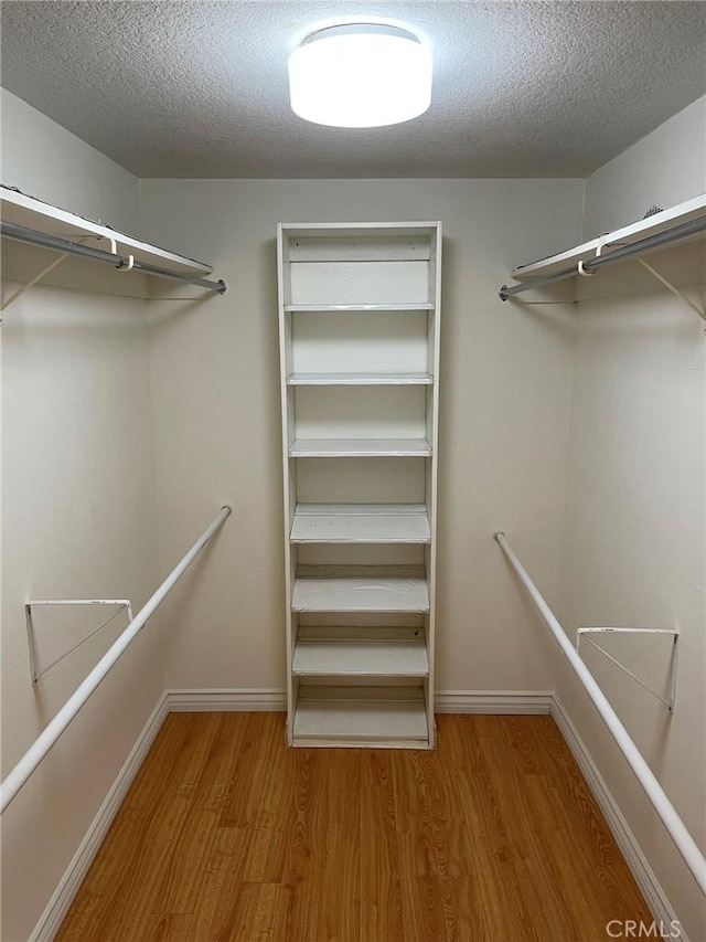 spacious closet with wood finished floors
