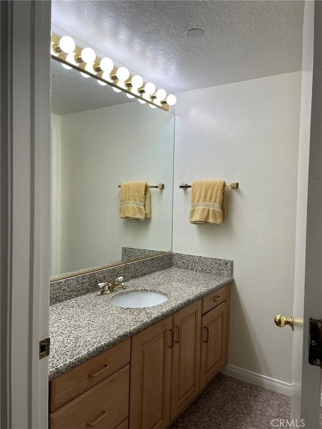 bathroom with vanity and baseboards
