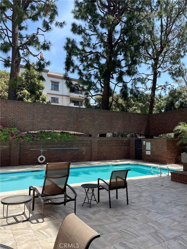view of pool featuring a fenced backyard and a patio area