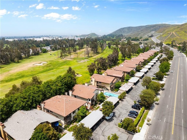 aerial perspective of suburban area featuring mountains and a golf course