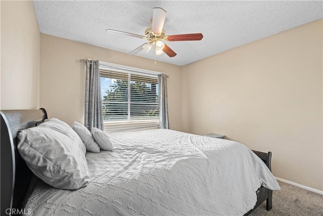 carpeted bedroom with baseboards, a textured ceiling, and a ceiling fan