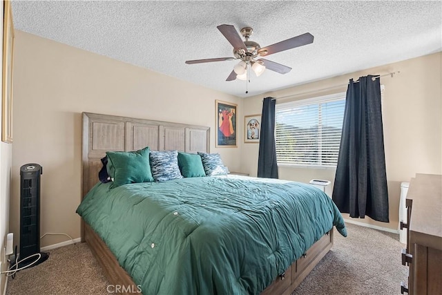 carpeted bedroom with baseboards, a ceiling fan, and a textured ceiling