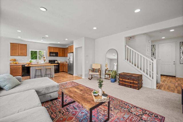 341 Dun Blazer Way, Fallbrook, CA 92028 - living room with recessed lighting, stairs, arched walkways, baseboards, and light wood-style flooring