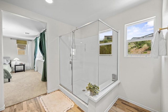 341 Dun Blazer Way, Fallbrook, CA 92028 - ensuite bathroom featuring a stall shower, plenty of natural light, and wood finished floors