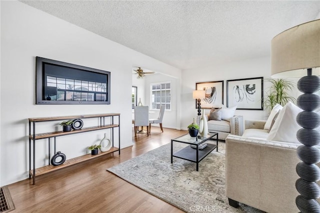 8873 Coolhurst Dr, Pico Rivera, CA 90660 - living room featuring wood finished floors, a textured ceiling, and ceiling fan