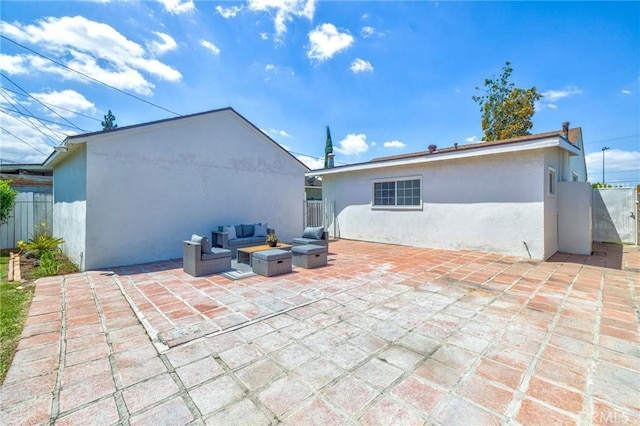 8873 Coolhurst Dr, Pico Rivera, CA 90660 - rear view of property featuring stucco siding, a patio area, an outdoor hangout area, and fence