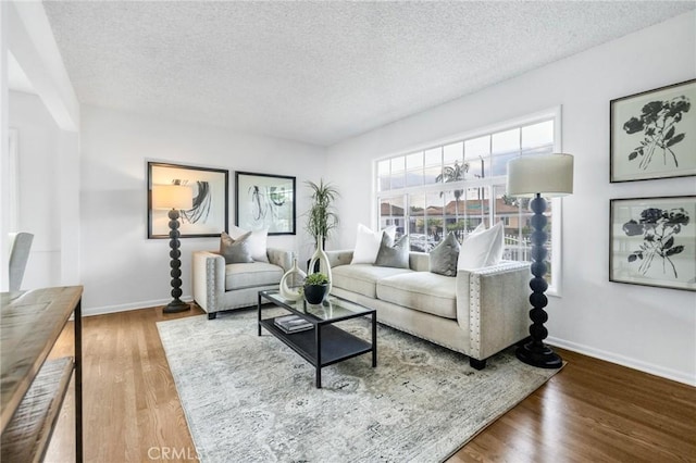 8873 Coolhurst Dr, Pico Rivera, CA 90660 - living area with baseboards, a textured ceiling, and wood finished floors