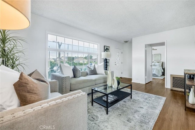 8873 Coolhurst Dr, Pico Rivera, CA 90660 - living room featuring a textured ceiling and dark wood-style floors