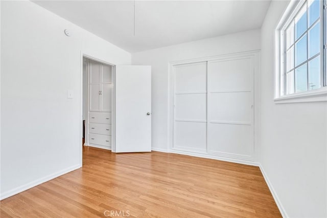 8873 Coolhurst Dr, Pico Rivera, CA 90660 - unfurnished bedroom with light wood-type flooring, a closet, and baseboards