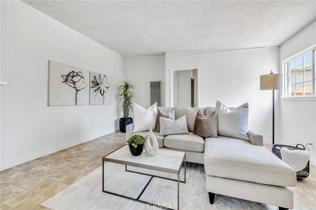 8873 Coolhurst Dr, Pico Rivera, CA 90660 - living room featuring a textured ceiling and baseboards