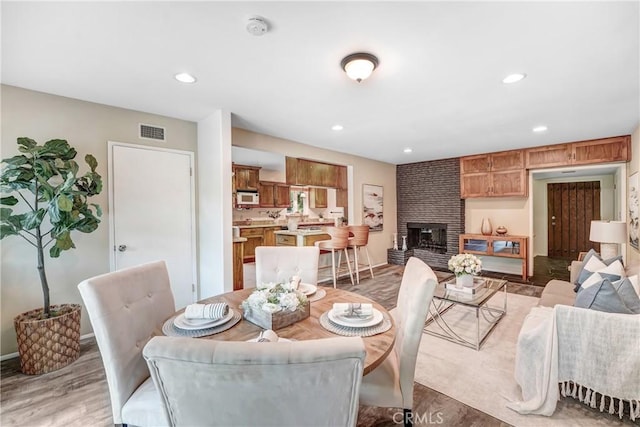 214 W Le Roy Ave, Arcadia, CA 91007 - dining area with a fireplace, recessed lighting, and light wood-style floors