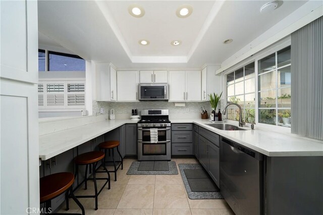 5158 Elderhall Ave, Lakewood, CA 90712 - kitchen with appliances with stainless steel finishes, a sink, gray cabinetry, decorative backsplash, and light tile patterned flooring