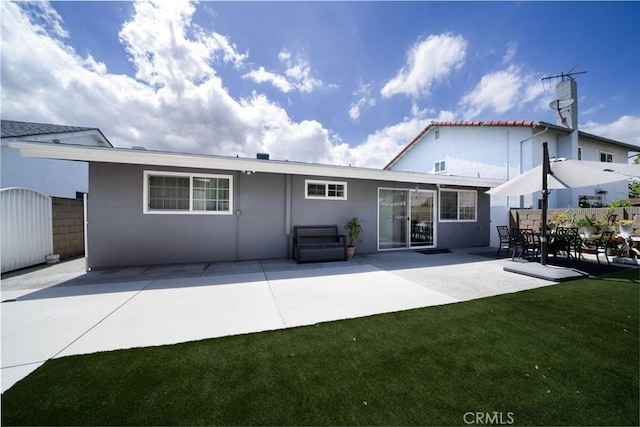 5158 Elderhall Ave, Lakewood, CA 90712 - rear view of house featuring stucco siding, a patio area, and a lawn