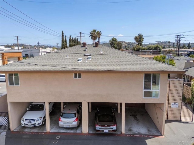 1278 E Madison Ave Unit D, El Cajon, CA 92021 - rear view of property with a shingled roof and stucco siding