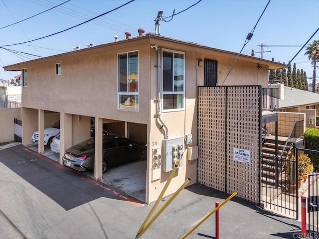 1278 E Madison Ave Unit D, El Cajon, CA 92021 - view of front of house featuring stucco siding and stairway