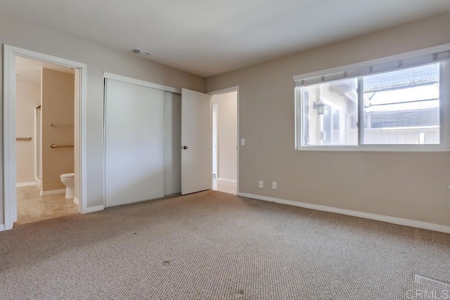 4379 Albatross Way, Oceanside, CA 92057 - unfurnished bedroom with carpet, ensuite bath, a closet, and baseboards