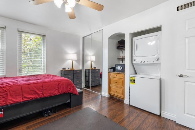 5510 Adelaide Ave Unit 1, San Diego, CA 92115 - bedroom with stacked washing machine and dryer, dark wood-style flooring, ceiling fan, and baseboards
