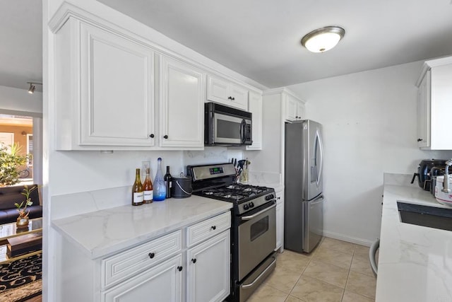 5510 Adelaide Ave Unit 1, San Diego, CA 92115 - kitchen with appliances with stainless steel finishes, white cabinets, light stone counters, and a sink