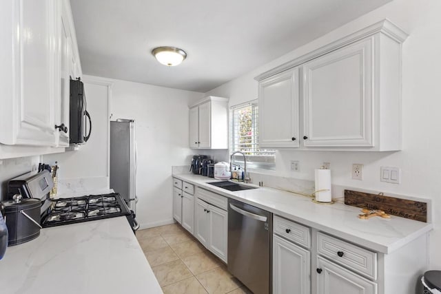 5510 Adelaide Ave Unit 1, San Diego, CA 92115 - kitchen featuring stainless steel appliances, a sink, white cabinets, and light stone countertops