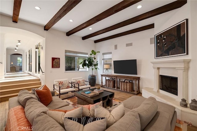 737 35th St, Manhattan Beach, CA 90266 - living area with arched walkways, recessed lighting, beamed ceiling, a fireplace with raised hearth, and wood finished floors