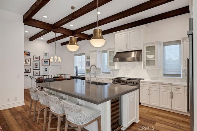 737 35th St, Manhattan Beach, CA 90266 - kitchen featuring under cabinet range hood, a sink, beverage cooler, beam ceiling, and backsplash