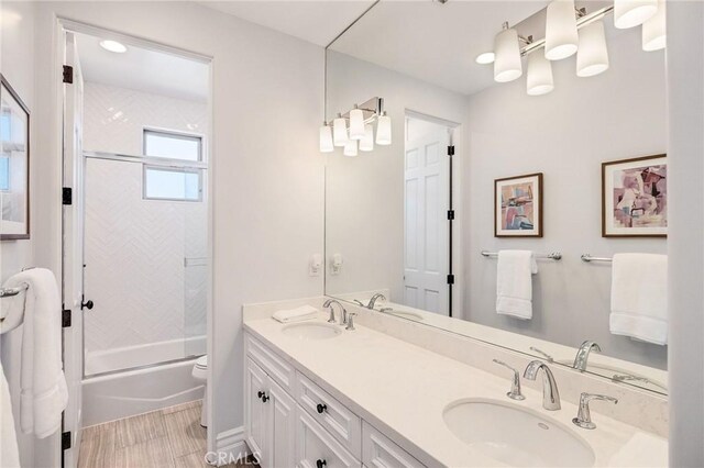 737 35th St, Manhattan Beach, CA 90266 - full bath with combined bath / shower with glass door, double vanity, toilet, and wood finished floors
