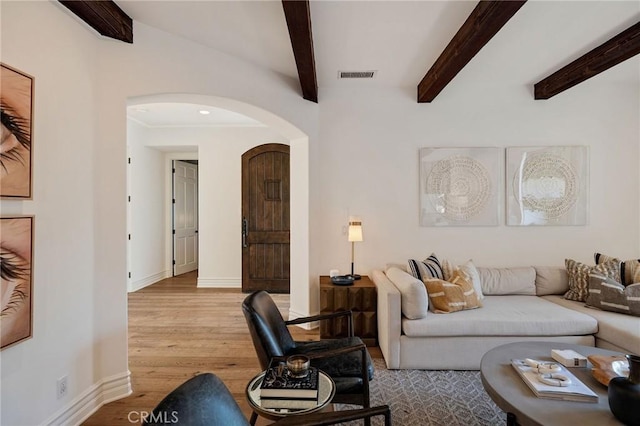 737 35th St, Manhattan Beach, CA 90266 - living area with arched walkways, wood finished floors, baseboards, and beam ceiling