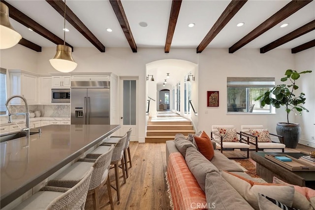 737 35th St, Manhattan Beach, CA 90266 - living area featuring arched walkways, light wood-type flooring, recessed lighting, stairs, and beam ceiling