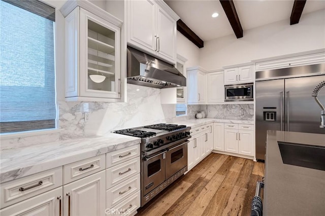 737 35th St, Manhattan Beach, CA 90266 - kitchen featuring built in appliances, under cabinet range hood, beam ceiling, light wood-type flooring, and white cabinetry