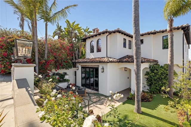 737 35th St, Manhattan Beach, CA 90266 - rear view of property featuring stucco siding, a patio, a tiled roof, and a lawn