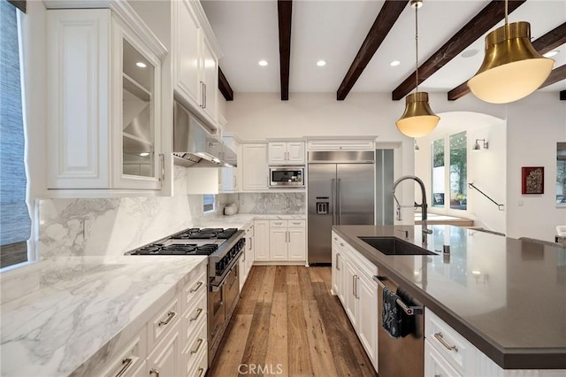 737 35th St, Manhattan Beach, CA 90266 - kitchen with built in appliances, a sink, under cabinet range hood, wood finished floors, and a spacious island