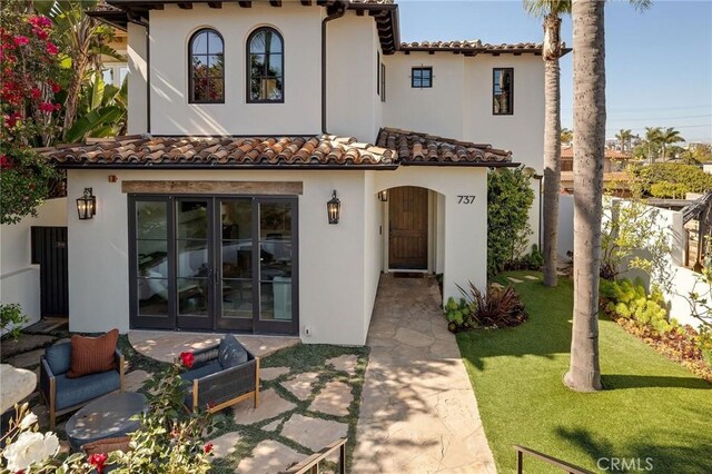737 35th St, Manhattan Beach, CA 90266 - view of front of home featuring stucco siding, a tile roof, a patio area, and french doors
