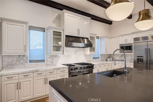 737 35th St, Manhattan Beach, CA 90266 - kitchen with under cabinet range hood, built in appliances, a sink, white cabinets, and beamed ceiling