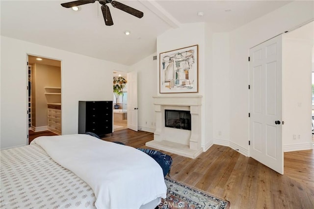 737 35th St, Manhattan Beach, CA 90266 - bedroom featuring wood finished floors, a glass covered fireplace, a spacious closet, baseboards, and recessed lighting
